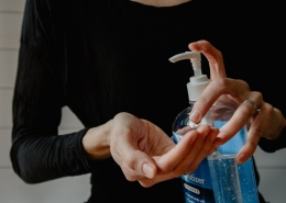 Lady using hand sanitizer